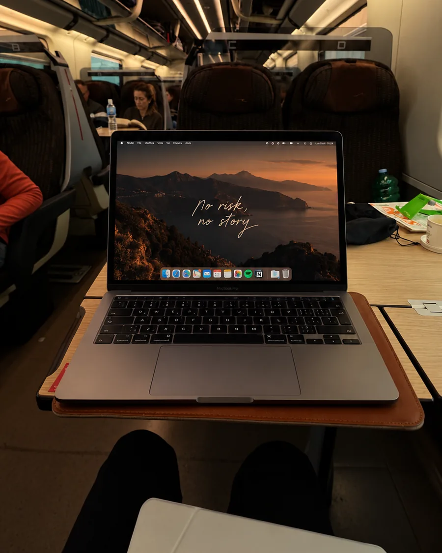 Computer portatile aperto sul tavolino di un treno ad alta velocità